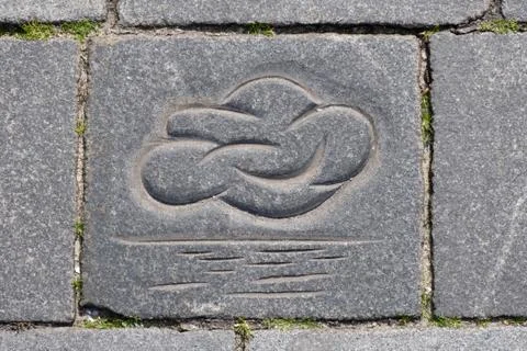 Cloud pattern on the stone sidewalk in the old european port city Stock Photos