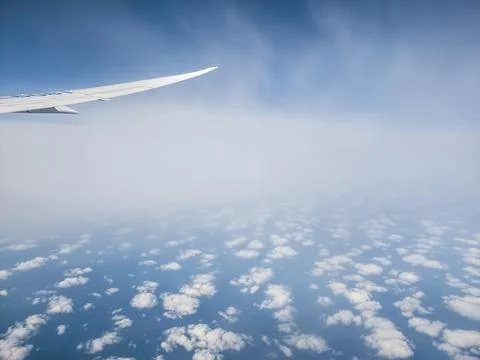 Cloud patterns with airplane flying between layers Fotos Stock
