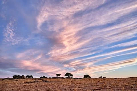Cloud patterns over a vast landscape in Extremadura at sunset showcasing na.. Stock Photos