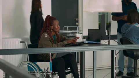 Cloud programmer in wheelchair using server data to create software app Stock Footage 231449011