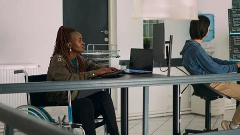 Cloud programmer in wheelchair using server data to create software app Stock Photos