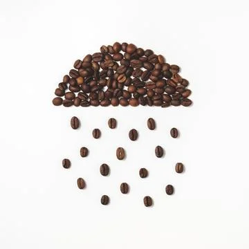 A cloud with a rain of coffee beans. Stock Photos