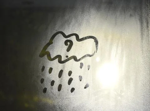 A cloud with raindrops is drawn on a window pane Stock Photos