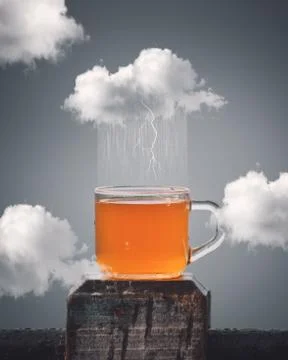 Cloud raining tea inside cup Stock Photos