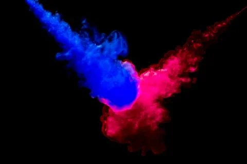 A cloud of red and blue paint released into clear water. Isolate on a black b Stock Photos