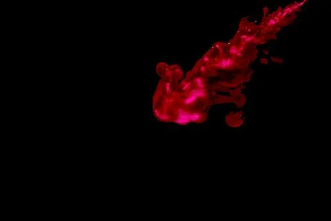 A cloud of red paint released into clear water. Isolate on a black background Stock Photos