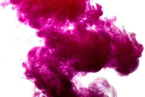 A cloud of red paint is released into the clear water. Isolate on a white bac Stock Photos