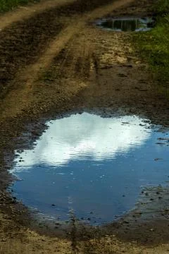 Cloud reflecting in a puddle on a path Cezallier plateau Auvergne Rhone Alpes Stock Photos