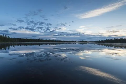 Cloud reflection in a forest lake, Norrbotten, Lapland, Sweden, July 2017 Stock Photos
