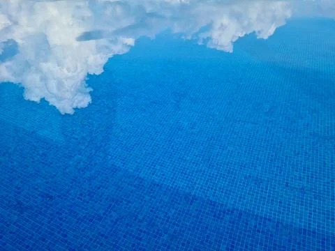 Cloud Reflection in a Sparkling Blue Pool Stock Photos