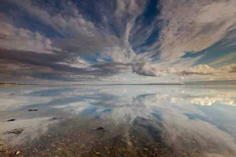Cloud reflections on a huge waterscape Stock Photos