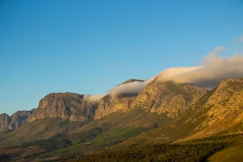 Cloud rolling over mountain at sir lowry's pass Stock Photos