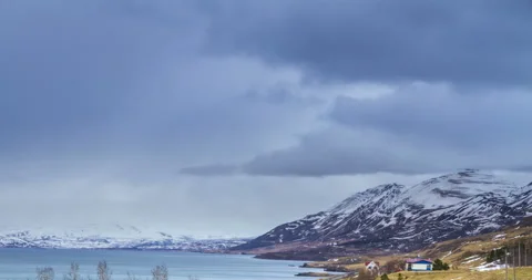 Cloud rolling time lapse over snow mountain fjords in Akureyri, Iceland. Stock Footage 136773223