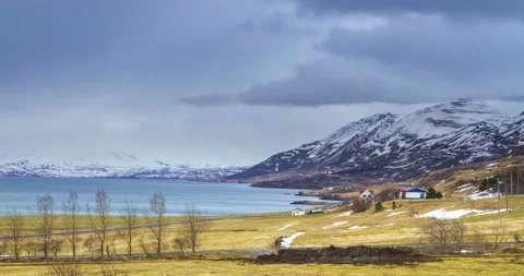 Cloud rolling time lapse over snow mountain fjords in Akureyri, Iceland. Stock Footage 136773250