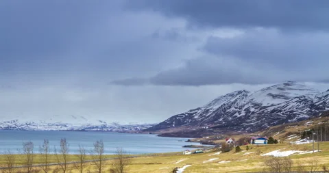Cloud rolling time lapse over snow mountain fjords in Akureyri, Iceland. Stock Footage 136773352