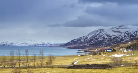Cloud rolling time lapse over snow mountain fjords in Akureyri, Iceland. Stock Footage 136773430