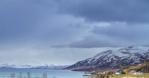 Cloud rolling time lapse over snow mountain fjords in Akureyri, Iceland. Stock Footage 136773633