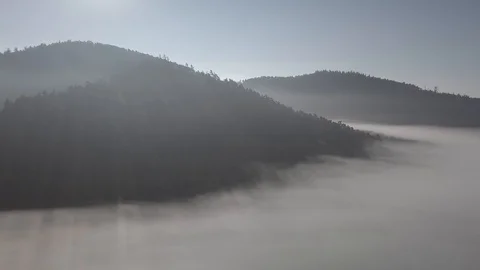 Cloud sea and mountains over light rays 4k ungraded Stock Footage 105849730