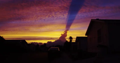 Cloud shadow creates an otherworldly sunset over this nondescript neighborhood. Stock Footage 234928363