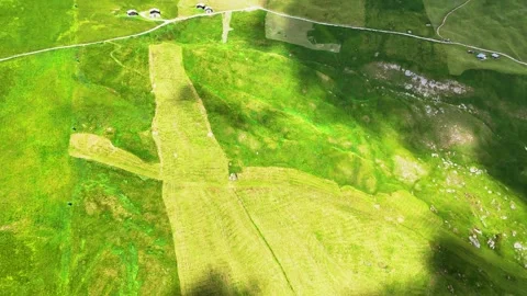 Cloud shadow moving over green hills and houses Stock Footage 285087152