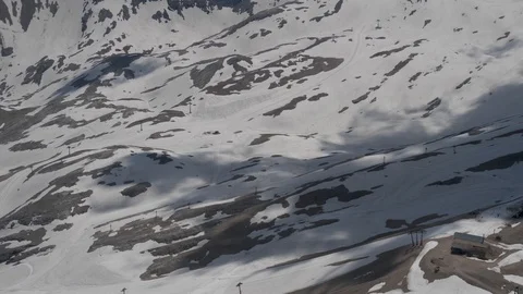 Cloud shadow over snow-covered mountain slope Stock-Footage 121004671