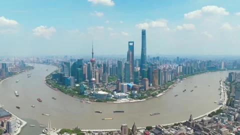 Cloud shadows and river traffic around the city peninsula in Shanghai Stock Footage 346590591