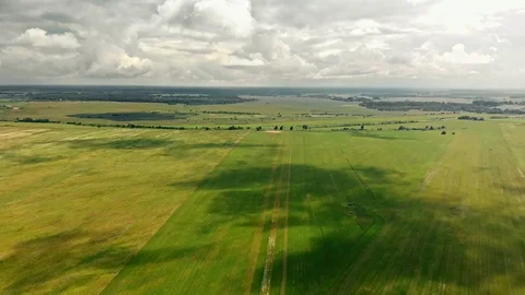 Cloud shadows crawl over green summer fields Stock Footage 109239017