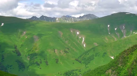 Cloud Shadows in Green and High Snowy Mountains Timelapse. Kavkaz region 스톡 동영상 65579475