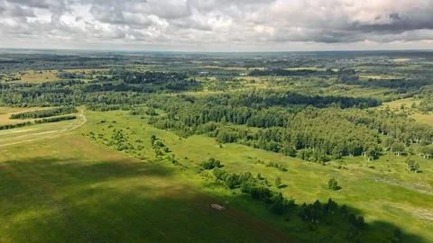 Cloud shadows pass over summer plains and forests Stock Footage 109237576