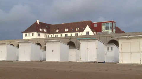 Cloud shadows passing over beach changing huts Stock Footage 55492327