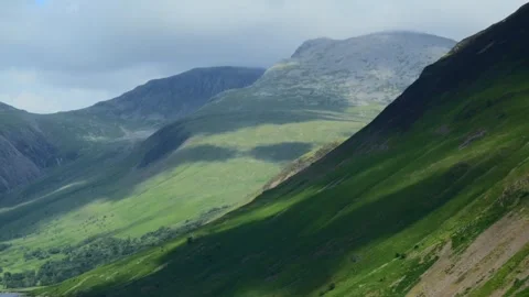 Cloud shadows racing across mountainside of Scafell as thick cloud skims Stock Footage 278450064