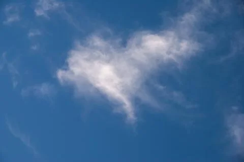 A cloud in a shape of heart in the blue sky Stock Photos