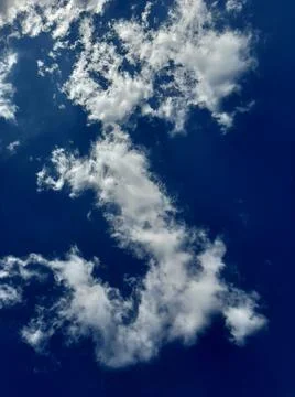 Cloud in the shape of the letter S in the sky Stock Photos
