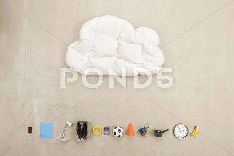 Cloud Shape Pillow With Variety Of Items On Beige Background