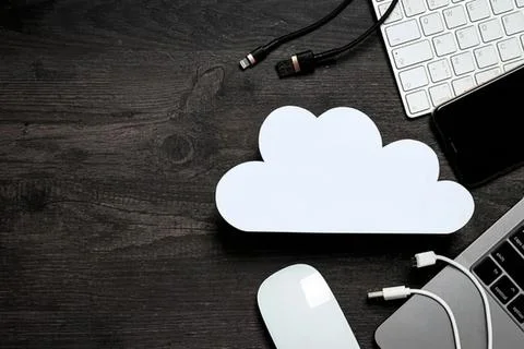 Cloud-shaped white cloud icon with keyboard and cables Stock Photos