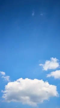 Cloud single lonely in high empty sky with beams vertical composition 16x9 with Stock Photos