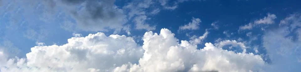 Cloud sky banner. Background fluffy white clouds panorama. Stock Photos