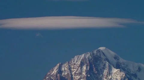 Cloud slowly disappearing on top of the Mt. Bianco from high Valsavarenche Stock Footage 10703664