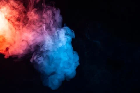 A cloud of smoke evaporating in soft waves with a rainbow effect: red, orange Stock Photos