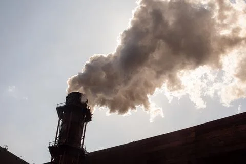 A cloud of smoke obscured the sun. Stock Photos