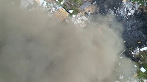 A cloud of smoke is rising from a pile of trash 스톡 동영상 325824294
