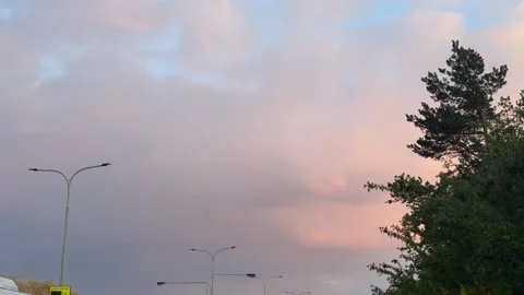 Cloud, soft pink and light blue sky drifting peacefully during a colorful Stock Footage 335380299