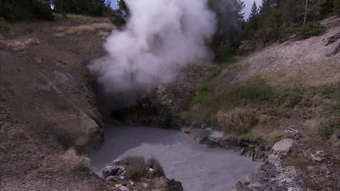 Cloud of steam rising from opening in Yellowstone National Park hot spring. Stock Footage 86755745