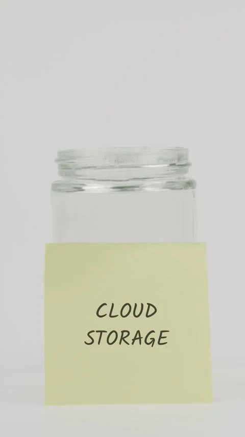 Cloud storage text or word on yellow sticky note attached to glass jar Stock Footage 311693142