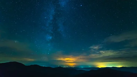 The cloud stream above mountains on the sunset background. time lapse Stock Footage 95184428