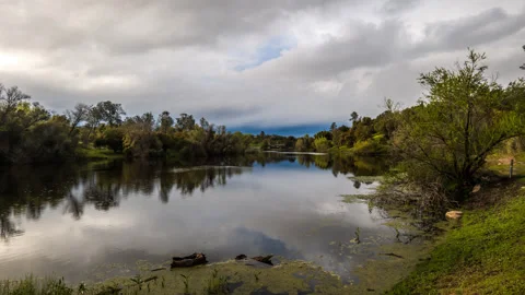 Cloud, Sun and Rain over Small Lake Time Lapse Stock Footage 278362561