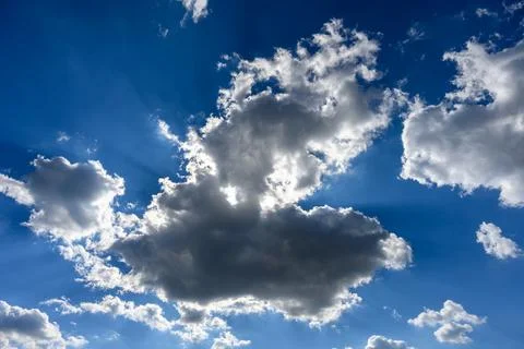 Cloud with sun shining behind and sun rays Stock Photos