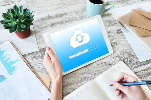 Cloud synchronization progress bar on tablet screen. Data storage and protection Stock Photos