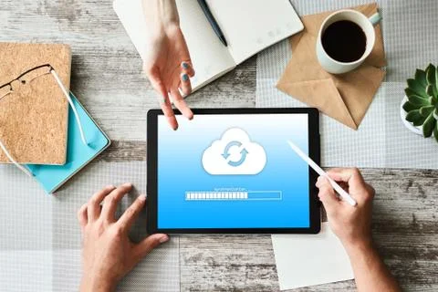Cloud synchronization progress bar on tablet screen. Data storage and protection Stock Photos