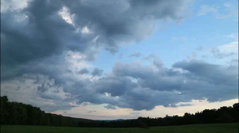 Cloud timelapse of a darkening sky over a field, 4K Stock Footage 65497806